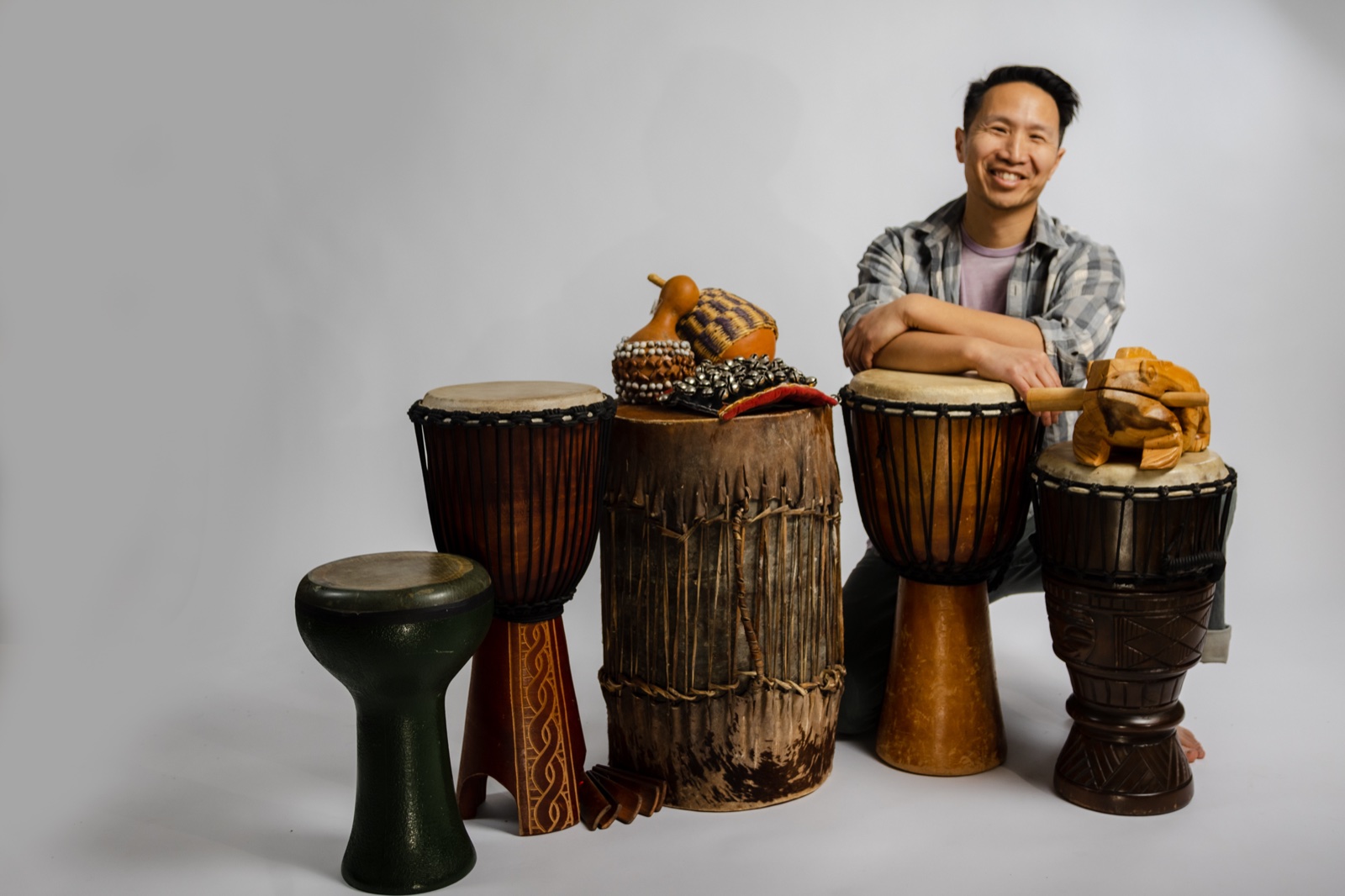 Marcus Fung with djembes and hand drums for team-building drum circles